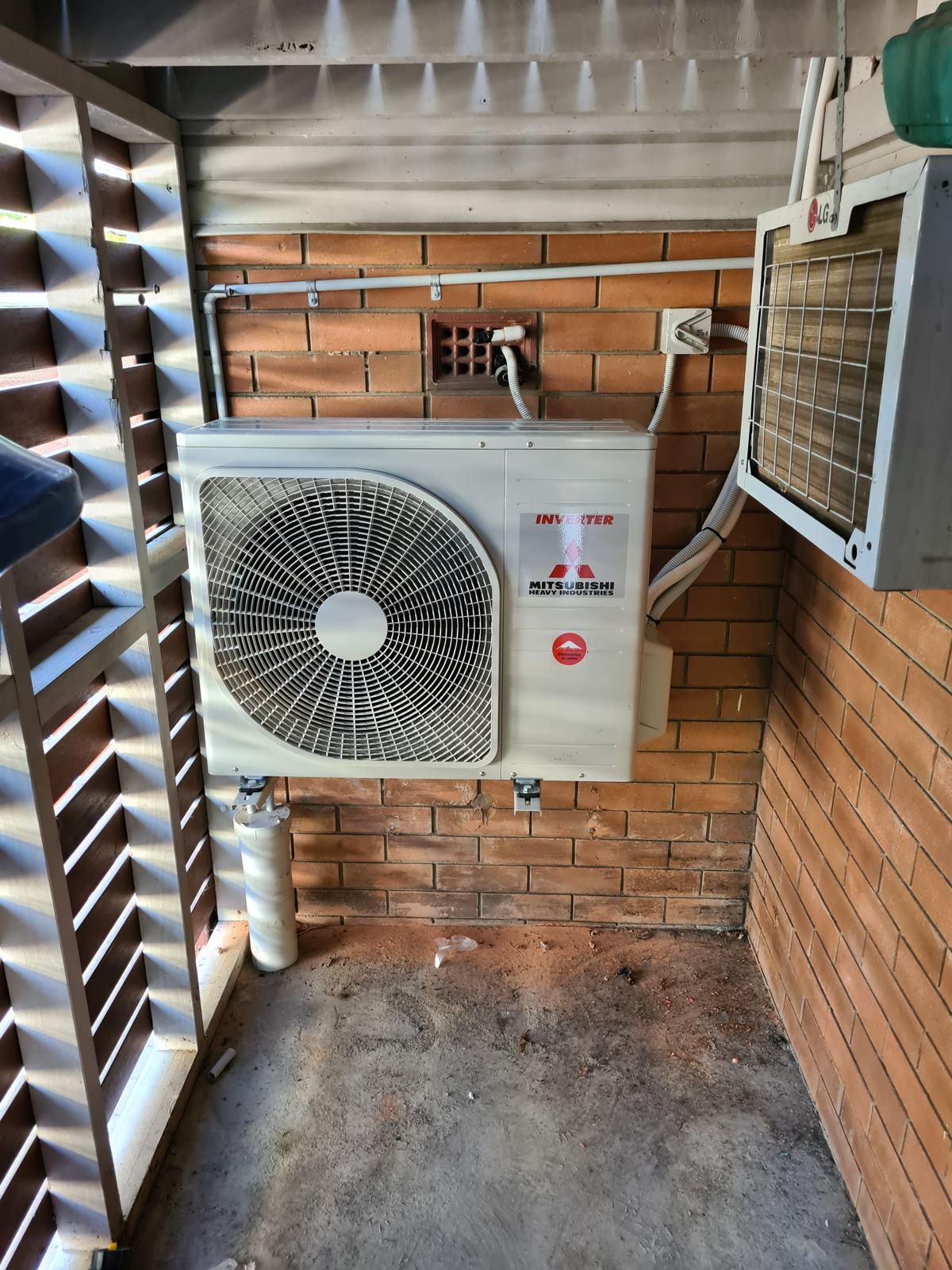 Split system outdoor unit on a timber-screened deck